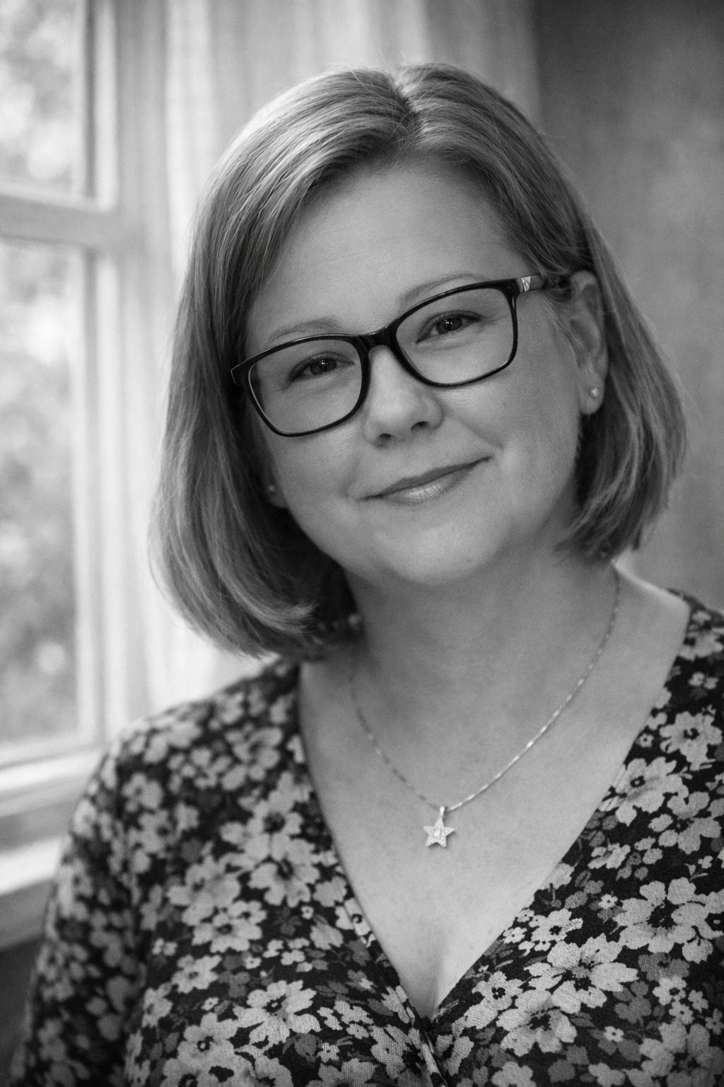 Sarah-Jayne, founder of Time to Talk Hub, smiling warmly in a softly-lit, homely setting